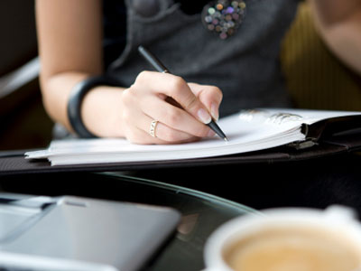 business-woman-writing-at-desk